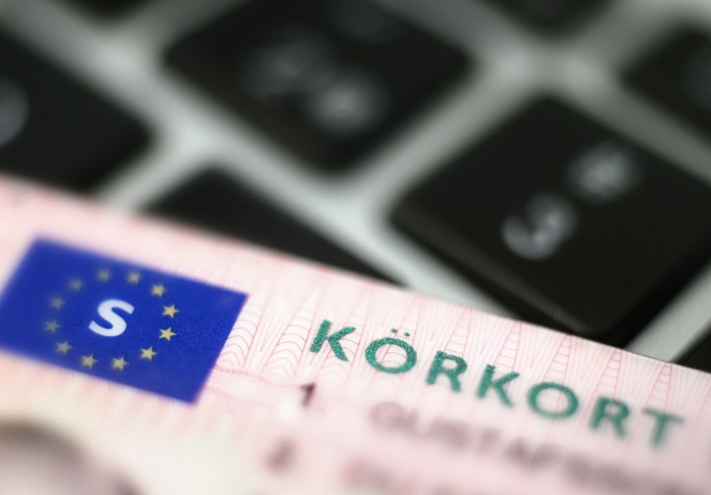 Rocky shoreline and tidal pools on Sweden’s High Coast, calm Baltic Sea waves under clear sky.